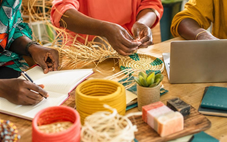 Hands collaborating on creative livelihood and business skills