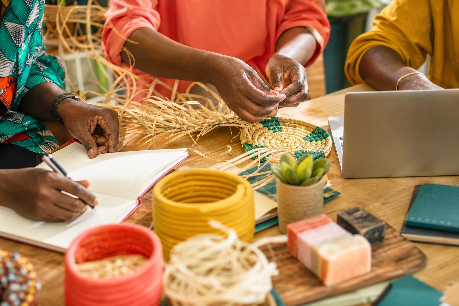 Hands collaborating on weaving, planning and digital livelihood skills